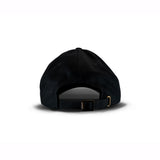 Solid black baseball cap viewed from behind, showing adjustable brass buckle strap